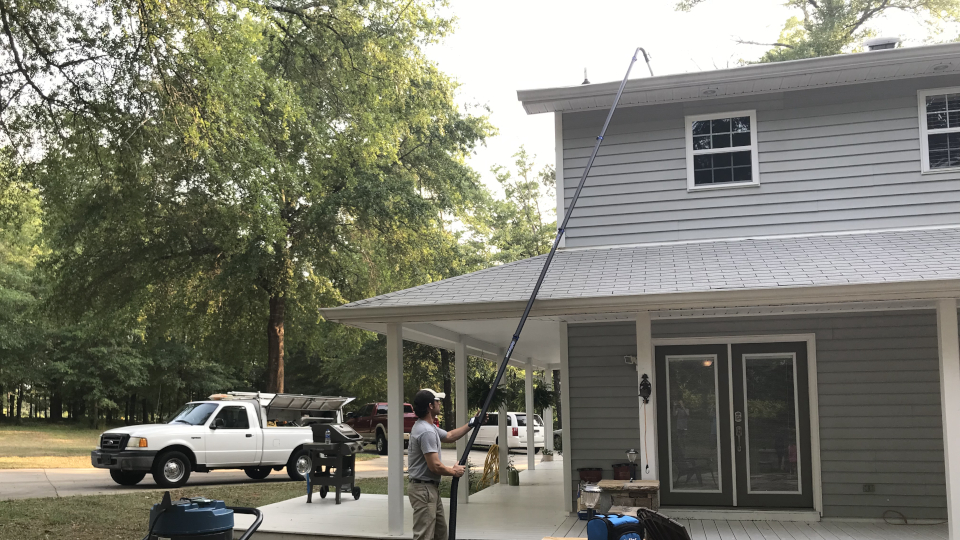 man cleaning gutters with vacuum